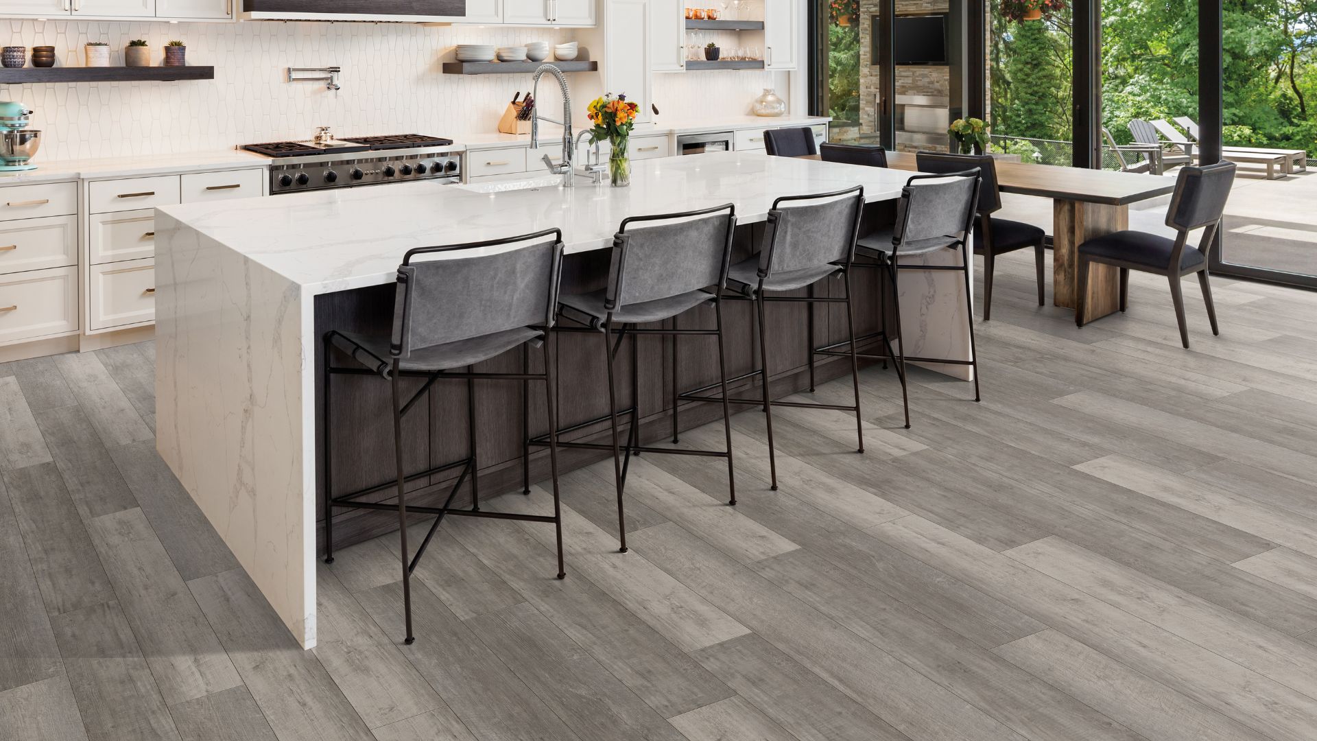 grey luxury vinyl plank flooring in a large open kitchen